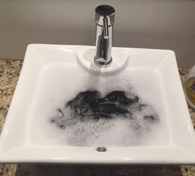 Wash Aulora Pants in sink